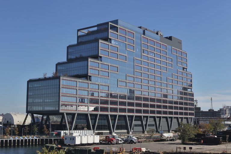 Dock 72, the office tower at the Brooklyn Navy Yard, seen between two active dry docks
