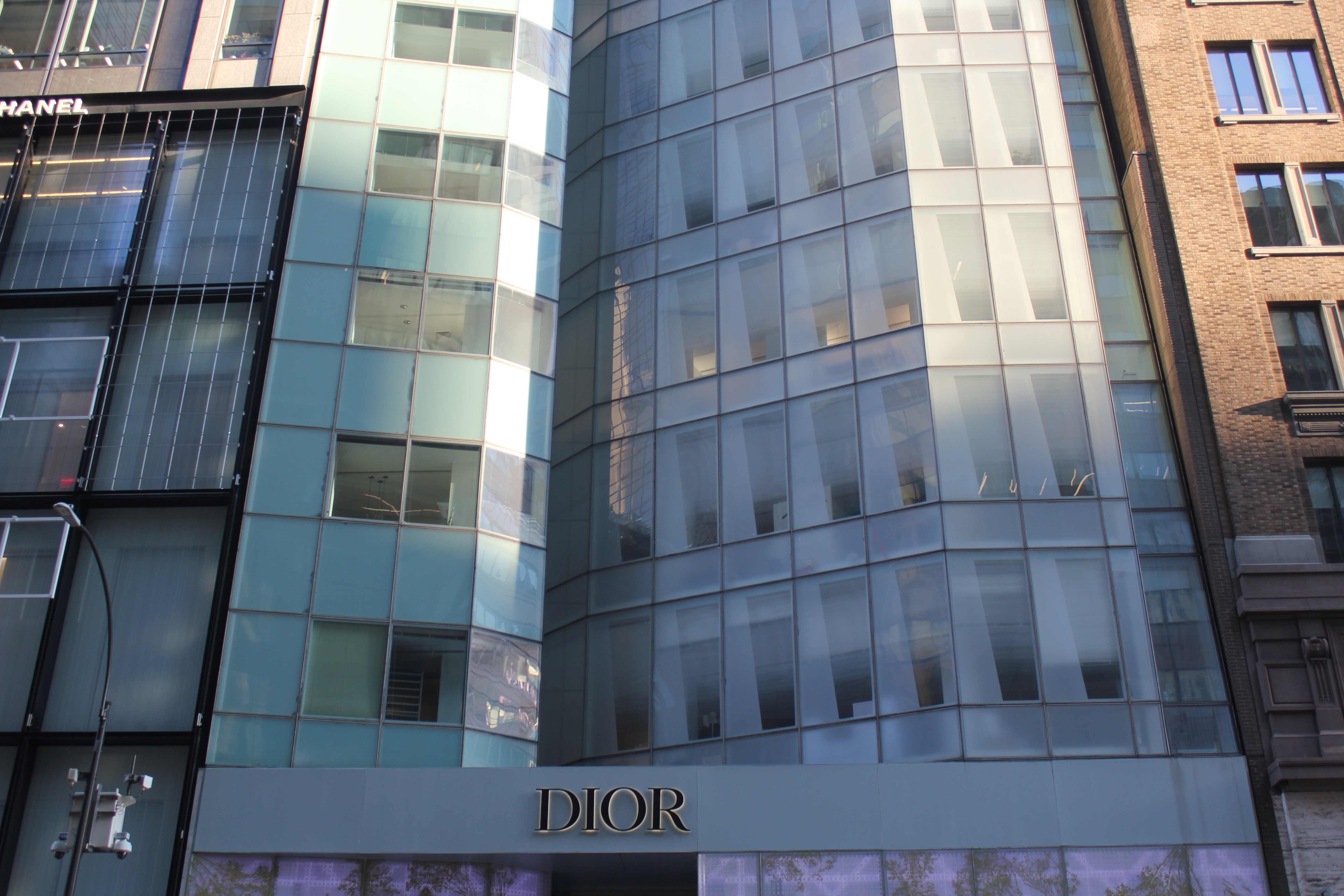 Street-level detail of the LVMH Tower facade fold and the Christian Dior retail base at 19 East 57th Street