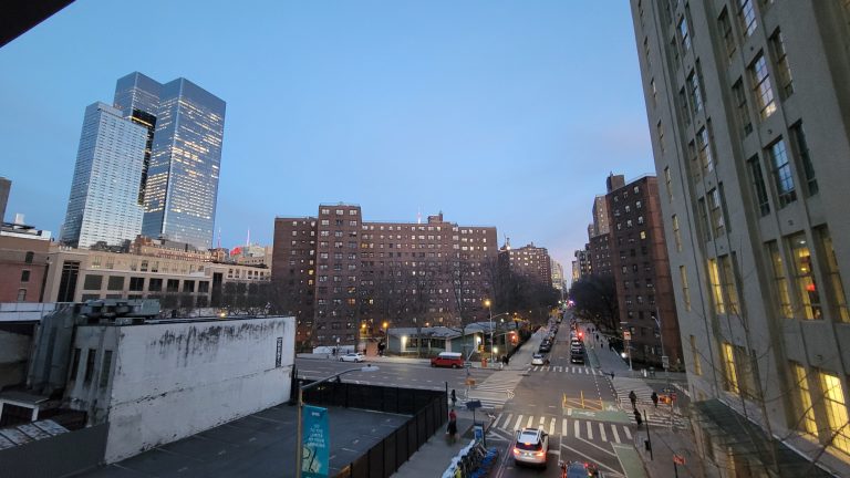 The Elliott-Chelsea Houses and West 26th Street seen from the High Line at dusk, with Manhattan West towers behind