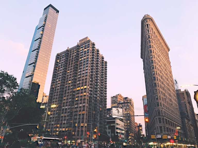 The Flatiron Building with residential towers rising behind it at Madison Square