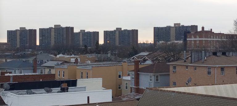 Rooftops and apartment towers seen from the 80th Street subway station in Ozone Park